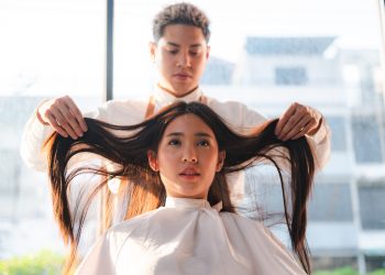 hairdresser and beautiful client woman making treatment hair health care in fashion style salon