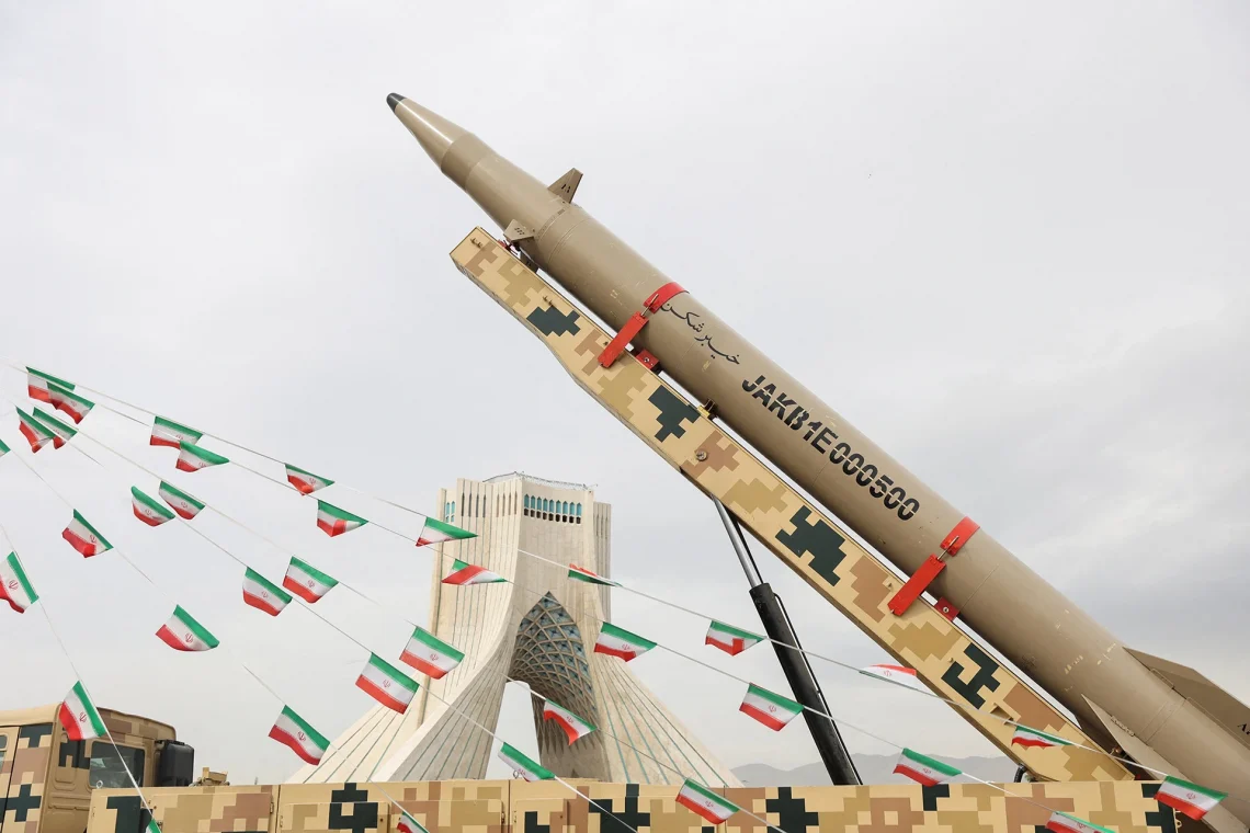 Iranian flags hang next to a missile on display during the forty-seventh anniversary of the Islamic Revolution in Tehran, Iran, February 11, 2026. Majid Asgaripour/WANA/Reuters