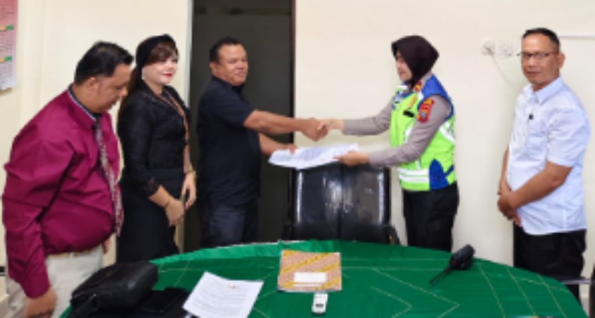 Penggugat Rindu Marpaung dan Kasat Lantas dari pihak tergugat bersalaman usai sepakat berdamai.