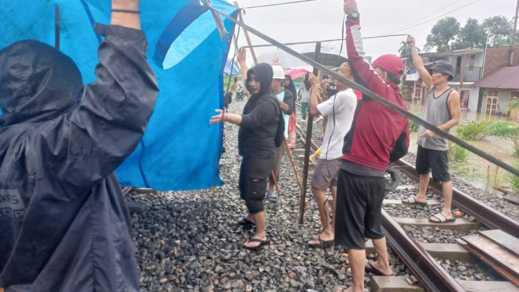 Anggota DPRD Kota Medan, Lailatul Badri saat mendirikan tenda darurat agar warga dapat berteduh setelah rumah yang ditempati diterjang banjir. (Foto Ist)