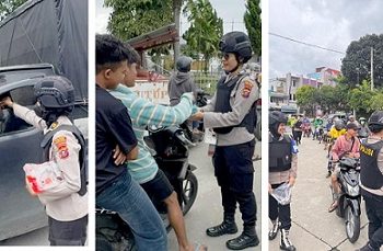 Ketua Tim 1 IPTU Suhaira Marbun bersama Srikandi Polwan saat bagikan air mineral dan permen kepada pengendara antri BBM di SPBU