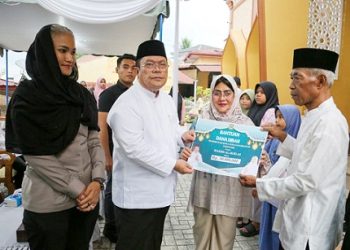 Walikota Pematangsiantar Wesly Silalahi SH MKn didampingi Ketua TP PKK Kota Pematangsiantar Ny Liswati Wesly Silalahi dan Kapolres Pematangsiantar AKBP Sah Udur T.M. Sitinjak SH. SIK. MH saat serahkan bantuan dana hibah Pemko Pematangsiantar secara simbolis untuk Masjid Al Ikhlas.