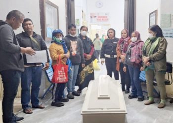 Kanit Reskrim IPDA B. Situngkir SH saat serahkan jenajah korban kepada keluarga untuk dikuburkan