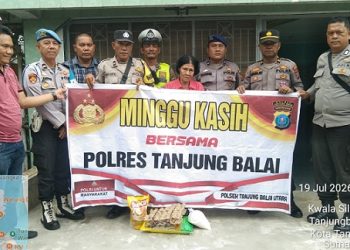 Ps. Kabagops AKP Natal Fernando Saragih, S.Pd bersama sejumlah personel lainnya. salurkan bansos kepada Ibu R. Manullang