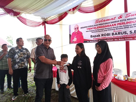 Ketua Fraksi PDI Perjuangan DPRD Kota Medan, Robi Barus SE M.AP bagikan masker ditengah kabut asap yang melanda ditengah pelaksanaan Sosialisasi Perda Kota Medan Nomor 6 Tahun 2023 tentang Penyelenggaraan Perlindungan Anak di Jalan Rezeki No. 9, Kelurahan Sei Sikambing D, Kecamatan Medan Petisah (Foto Ist)
