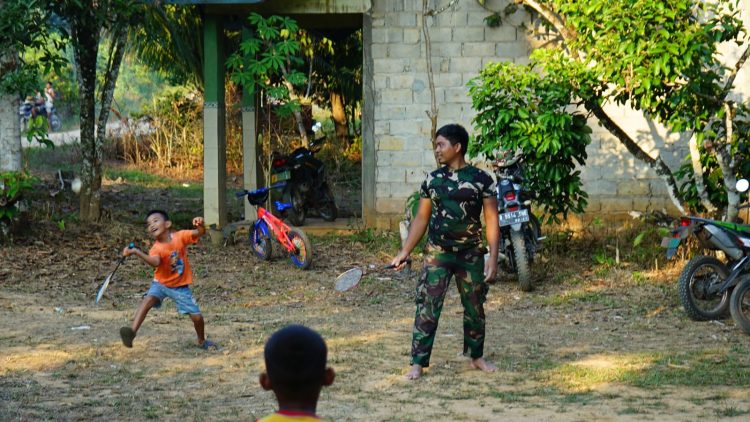 Praka Saenal dan Pratu Harahap anggota satgas TMMD yang terlihat bermain bulutangkis bersama anak-anak desa.