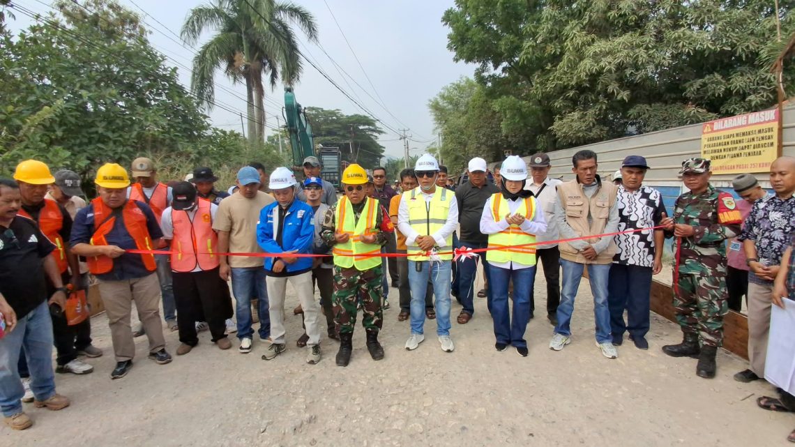 Bersama - sama melakukan gunting pita oleh Camat, Kades, Danramil tanda dimulai pembanguna jalan dengan anggaran APBD Kabupaten