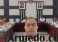 Kadis Kominfo Andri Rahadian menatap lensa kamera membelakangi suasana rapat Pansus LKPJ